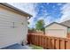 Fenced backyard with garage and view of the sky at 18324 E Bethany Pl, Aurora, CO 80013