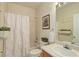 Bathroom featuring shower-tub combination, plants, a window, and neutral decor at 18324 E Bethany Pl, Aurora, CO 80013