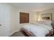 Bright bedroom featuring a cozy bed, neutral walls, and a window with wood blinds at 18324 E Bethany Pl, Aurora, CO 80013