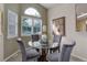 Inviting dining area with glass table, plush seating, and plenty of natural light at 18324 E Bethany Pl, Aurora, CO 80013