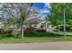 Charming home with manicured lawn, mature trees, and inviting entryway at 18324 E Bethany Pl, Aurora, CO 80013