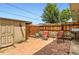 Private backyard with storage shed, cozy patio, wood fence, and a small garden area at 8613 Santa Fe Dr, Thornton, CO 80260