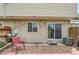 Backyard patio with seating, grill, and sliding glass door access to the home at 8613 Santa Fe Dr, Thornton, CO 80260