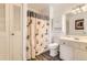 Bathroom featuring a shower with a patterned curtain, and a vanity with marbled countertop at 8613 Santa Fe Dr, Thornton, CO 80260