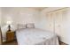 Cozy bedroom featuring a comfortable bed, side table with lamp, and a closet at 8613 Santa Fe Dr, Thornton, CO 80260