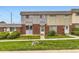 Exterior view of townhomes with brick facade and well-kept lawns and minimal landscaping at 8613 Santa Fe Dr, Thornton, CO 80260