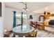 Kitchen dining area features a glass table, wood cabinets, stainless steel appliances, and outdoor access at 8613 Santa Fe Dr, Thornton, CO 80260