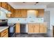 Traditional kitchen featuring wooden cabinets, stainless steel appliances, and stylish countertops at 8613 Santa Fe Dr, Thornton, CO 80260
