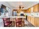 Functional kitchen features a breakfast bar, stainless steel appliances, and wood cabinets for storage at 8613 Santa Fe Dr, Thornton, CO 80260