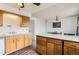 Bright kitchen with wooden cabinets, a center island, and an adjacent dining area at 8613 Santa Fe Dr, Thornton, CO 80260