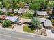 Aerial view showcasing the home with a manicured front yard, mature trees, and a desirable location in a quiet neighborhood at 5920 Garrison St, Arvada, CO 80004