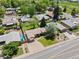 Aerial view showcasing the home with a manicured lawn, mature trees, and proximity to local parks and recreation areas at 5920 Garrison St, Arvada, CO 80004