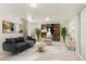 Finished basement featuring a comfortable couch, shelving, plants, and stylish decor at 5920 Garrison St, Arvada, CO 80004