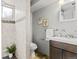 Bathroom featuring gray tile, a glass enclosed shower, and a dark wood vanity with a light countertop at 5920 Garrison St, Arvada, CO 80004