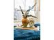 Bedroom decor featuring a decorative vase, clock, and wooden tray on a cozy blue bedspread at 5920 Garrison St, Arvada, CO 80004