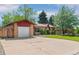 A single-story home with a brick facade, a well-maintained lawn, and a wide driveway at 5920 Garrison St, Arvada, CO 80004