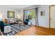 Well-lit living room with a large window, comfortable seating, and elegant decor, perfect for relaxing at 5920 Garrison St, Arvada, CO 80004