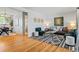 Open-concept living area connecting to the dining space, highlighted by hardwood floors and modern decor at 5920 Garrison St, Arvada, CO 80004