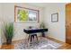 Home office featuring a black desk with gold legs, a window view, and tasteful decor at 5920 Garrison St, Arvada, CO 80004