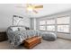 Bedroom with a ceiling fan and large windows and a chest at the foot of the bed at 1775 W 130Th Pl, Westminster, CO 80234