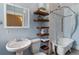 Stylish bathroom featuring open wooden shelves and a classic clawfoot tub at 2566 N Emerson St, Denver, CO 80205