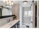Stylish bathroom featuring a vanity with sink, decorative mirror, sliding barn door, and modern fixtures at 2566 N Emerson St, Denver, CO 80205