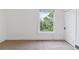 Simple bedroom with a window offering natural light, neutral carpet flooring, and a spacious feel at 2566 N Emerson St, Denver, CO 80205