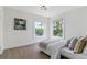 Bedroom with neutral decor featuring two windows overlooking greenery and comfortable furnishings at 2566 N Emerson St, Denver, CO 80205