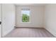 Airy bedroom features a neutral color scheme with natural light from the window at 2566 N Emerson St, Denver, CO 80205
