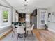 Charming dining area with modern decor, an adjacent kitchen, and ample natural light from the large windows at 2566 N Emerson St, Denver, CO 80205