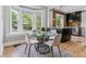 Bright dining area featuring a glass-top table, modern chairs, and a large bay window offering scenic outdoor views at 2566 N Emerson St, Denver, CO 80205