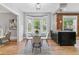 Cozy dining area with hardwood floors, modern decor, open to the kitchen, and bay windows with pleasant outdoor views at 2566 N Emerson St, Denver, CO 80205