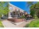 Charming multi-story home featuring a landscaped front yard and a classic brick facade with a welcoming covered porch at 2566 N Emerson St, Denver, CO 80205