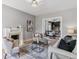 Bright and airy living room with a fireplace, hardwood floors, an open layout, and a view of the modern kitchen at 2566 N Emerson St, Denver, CO 80205