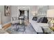 Comfortable living room featuring hardwood floors, a stylish rug, and an open layout to the dining area at 2566 N Emerson St, Denver, CO 80205