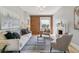 Cozy living room with a decorative fireplace, exposed brick, and ample natural light from the large window at 2566 N Emerson St, Denver, CO 80205