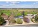 Aerial view of home near a golf course with mature trees and manicured lawns on a sunny day at 12391 E Cedar Cir, Aurora, CO 80012