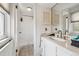 Well-lit bathroom with a shower, vanity, and updated fixtures at 12391 E Cedar Cir, Aurora, CO 80012