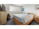 Bright bedroom with a large window, neutral walls, and plush carpeting at 12391 E Cedar Cir, Aurora, CO 80012