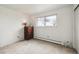 Bedroom featuring a hardwood dresser, window and plush carpet at 12391 E Cedar Cir, Aurora, CO 80012