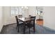 Carpeted dining area with a wood table and view of the kitchen at 12391 E Cedar Cir, Aurora, CO 80012