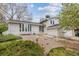 Home featuring a well-maintained exterior with a white brick facade, bay window, and minimalist landscaping at 12391 E Cedar Cir, Aurora, CO 80012