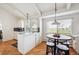 Bright eat-in kitchen with white cabinetry, island, and scenic view at 12391 E Cedar Cir, Aurora, CO 80012