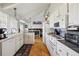Bright eat-in kitchen with white cabinetry, white appliances, and hardwood floors at 12391 E Cedar Cir, Aurora, CO 80012