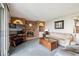 Comfortable living room with a decorative brick fireplace and a large TV at 12391 E Cedar Cir, Aurora, CO 80012