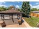Landscaped backyard features a shed with bench seating and a green lawn at 753 S Utica St, Denver, CO 80219