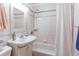 Cozy bathroom featuring tiled shower and floors, and a decorative floral border at 753 S Utica St, Denver, CO 80219