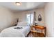 Cozy bedroom with vintage wallpaper, hardwood floors and a street view window at 753 S Utica St, Denver, CO 80219