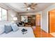 Bright bedroom featuring hardwood floors, a ceiling fan, and an ample mirrored closet at 753 S Utica St, Denver, CO 80219