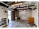 Spacious garage with concrete floors, an open door, workbench, storage, and excellent potential at 753 S Utica St, Denver, CO 80219